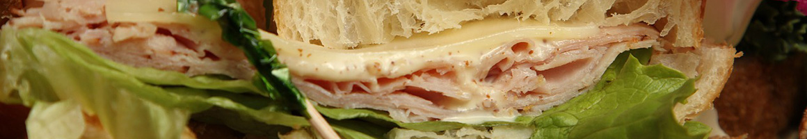 Eating Deli Sandwich at Royal Bagel Bakery & Deli restaurant in Germantown, MD.